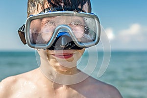 Closeup of boy face in the snorkeling mask and tube. Travel and summer concept. Ð¡hildren`s diving.