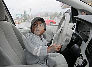 Closeup of a boy holding steering