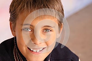 Closeup of boy smiling against colorful background