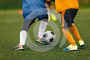 Closeup of Boys Kicking Soccer Ball. Running Soccer Football Players.