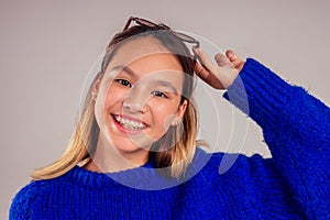 Closeup Braces smile portrait of caucasian Asian smilling and taking selfie white background studio
