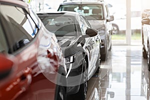 Closeup of brand new luxury automobiles in vip showroom