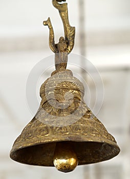 Closeup of Brass bell hung in front of deity in Hindu temple