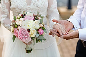 Closeup with bride and groom hands
