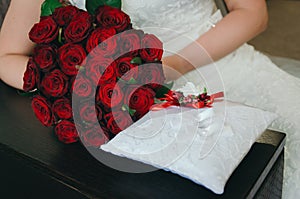 Closeup with bride and groom hands and bouquet. Bride, holding a wedding bouquet of flowers. Wedding silver rings. Bridal wedding