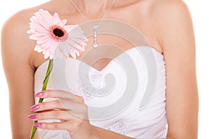 Closeup of bride white wedding dress with flower