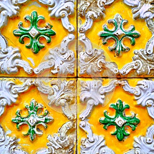 A closeup of bright colourful Portuguese tiles with crumbling enamel