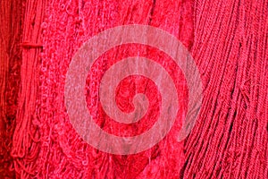 Closeup of bright pink fabric wools in a market