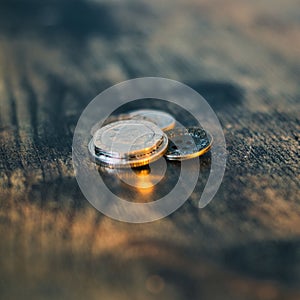 Closeup of British coins on a wooden surface