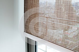 Closeup brown color roller blinds curtains.
