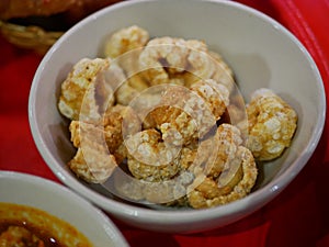 Closeup of brown crispy deep fried pork lard crackling khaep mu - famous and popular small side dish among the Thais