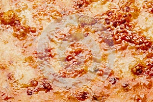 Closeup of browned cheese crust on pizza bolognese with mincemeat and tomato sauce