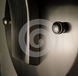Abstract face in closeup of brushed nickle metal sconce. photo