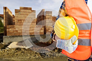 Closeup of builder man holding helmet