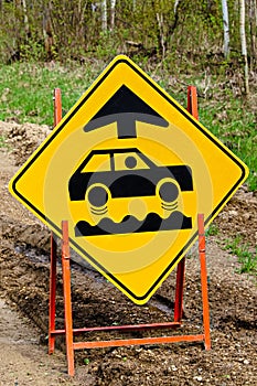 Closeup of a bumpy road ahead sign