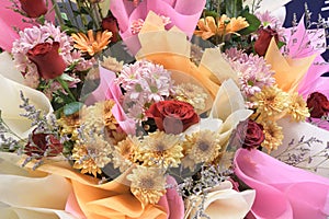 A closeup of a bunch bouquet of artificial flowers at an opening ceremony