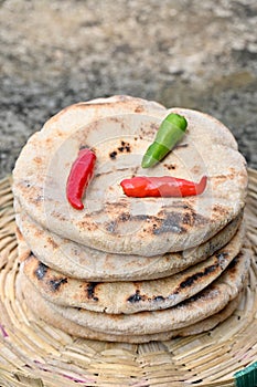 closeup the bunch brown color brown tortilla with red green chilly and green mint in the brown bucket on the soft focus natural