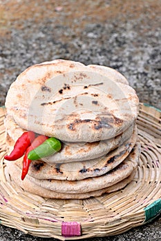 closeup the bunch brown color brown tortilla with red green chilly and green mint in the brown bucket on the soft focus natural