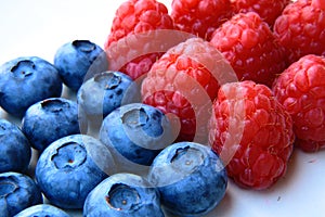 Closeup of a bunch of raspberries and blueberries