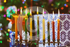 Closeup of a burning Chanukah candlestick with candles Menorah