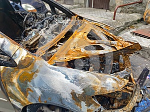 Closeup of burnt car on the city street arsoned by vandals