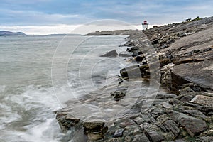 Closeup of a Burry Port beach with rocks around and gloomy sky background