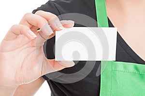 Closeup of business card in hypermarket employee hand