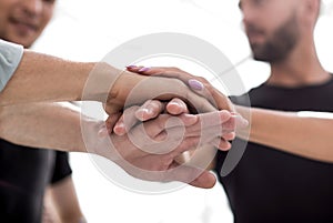 Closeup of a business colleagues with their hands stacked togeth