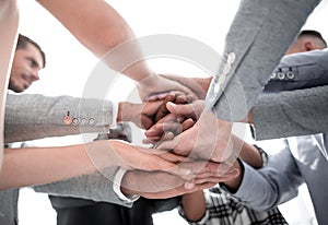 Closeup of a business colleagues with their hands stacked togeth