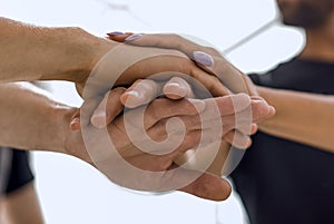 Closeup of a business colleagues with their hands stacked togeth