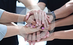 Closeup of a business colleagues with their hands stacked togeth