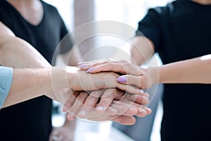 Closeup of a business colleagues with their hands stacked together