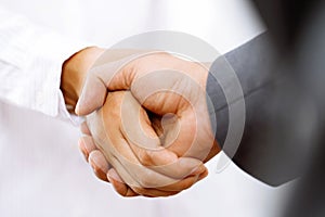 Closeup of a business hand shake between two colleagues