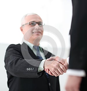 Closeup of a business handshake partners. the image is blurred.