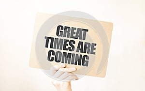 Closeup Business man hand holding show blank paper sheet mock up GREAT TIMES ARE COMING