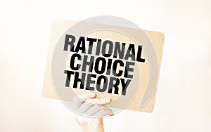 Closeup Business man hand holding show blank paper sheet mock up RATIONAL CHOICE THEORY