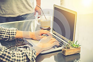 Closeup of business man hand typing on laptop on the table