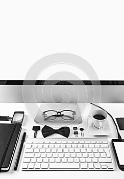 Closeup of business objects in order on white desk.