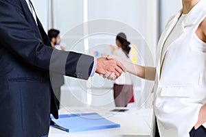 closeup of business partners shaking hands after concluding a business finished. Businessman and Businesswoman handshake in office
