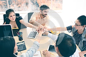 Closeup of business team putting their hands on top of each other