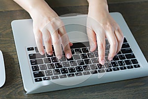 Closeup of business woman hand typing on laptop keyboar