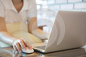 Closeup of business woman hand typing on laptop keyboard