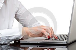 Closeup of business woman hand typing on laptop keyboard