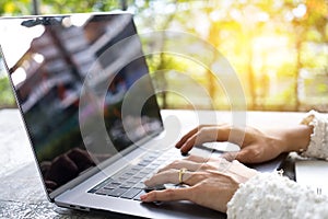 Closeup business woman hands typing on laptop keyboard on desk.