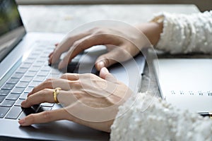 Closeup business woman hands typing on laptop keyboard on desk.