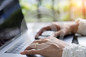 Closeup business woman hands typing on laptop keyboard on desk.