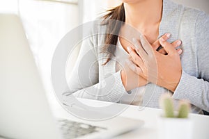 Closeup business woman having heart attack.