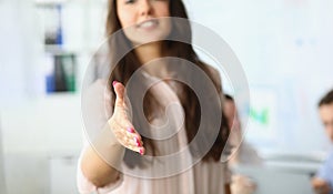 Closeup of business woman holding out hands for handshake and welcome gesture