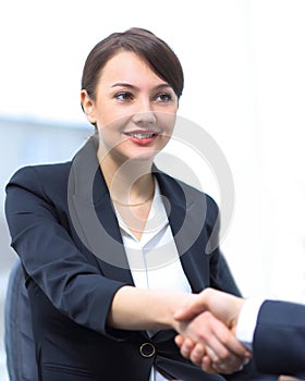 Closeup of business woman shaking hands with her colleague.