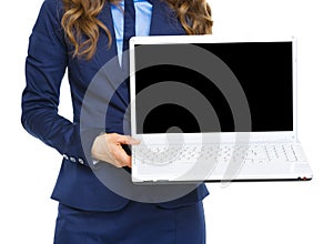 Closeup on business woman showing laptop blank screen